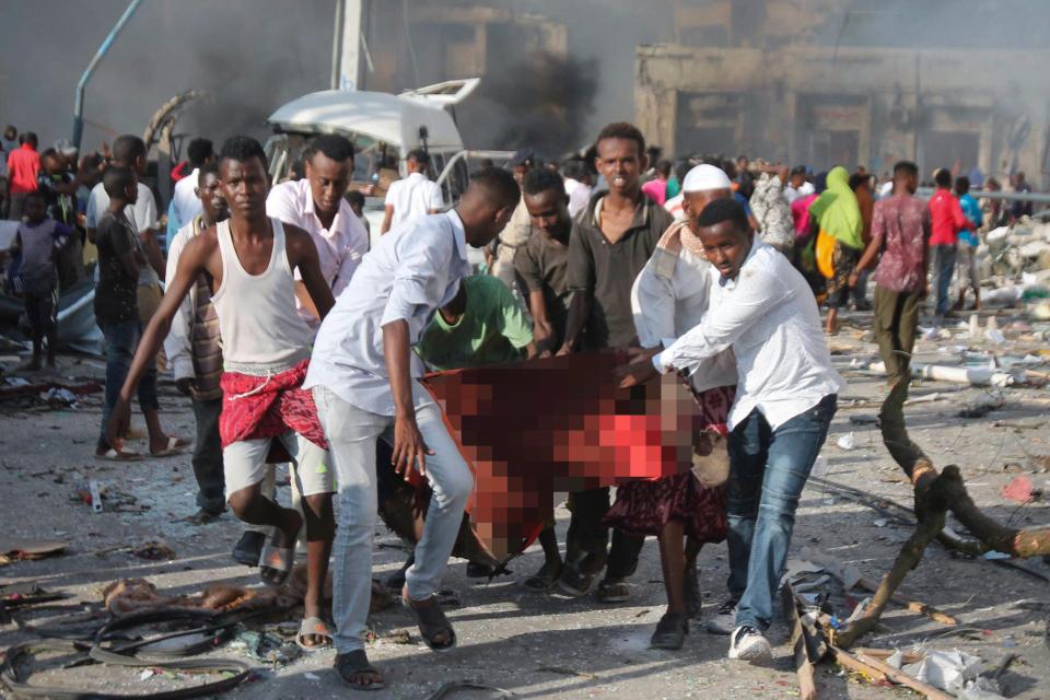  A man being carried away from the blast outside the Safari Hotel