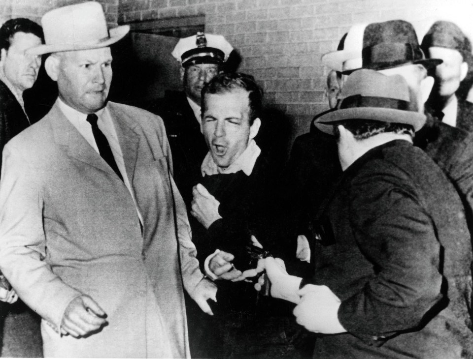 Oswald was shot by Jack Ruby while in police custody (pictured) 