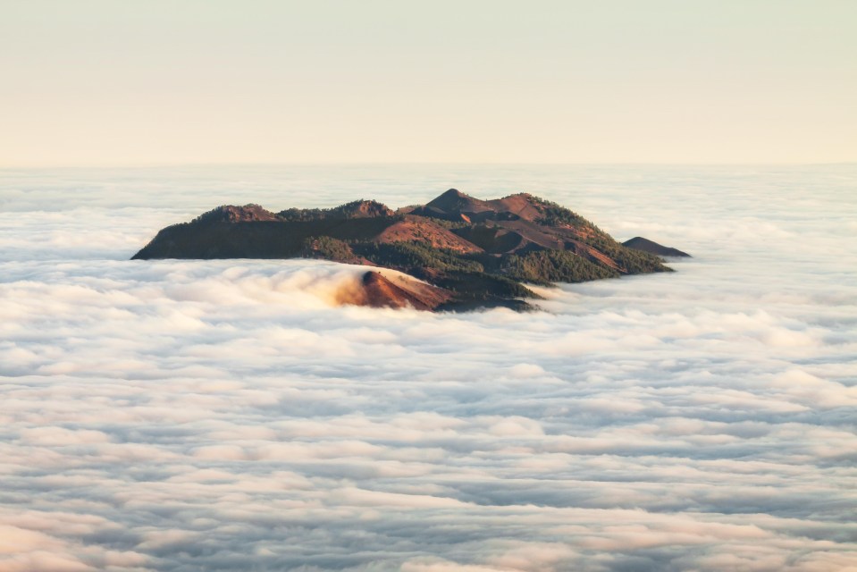 The top of Cumbre Vieja volcano pokes through the clouds on La Palma 