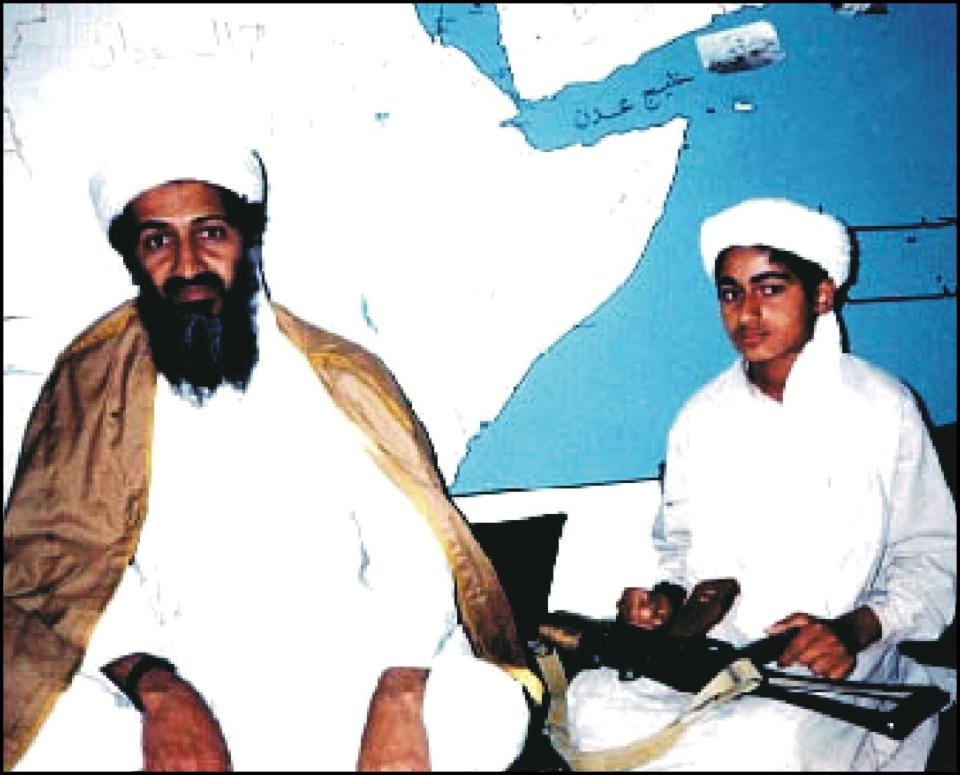  Osama bin Laden pictured with one of his sons