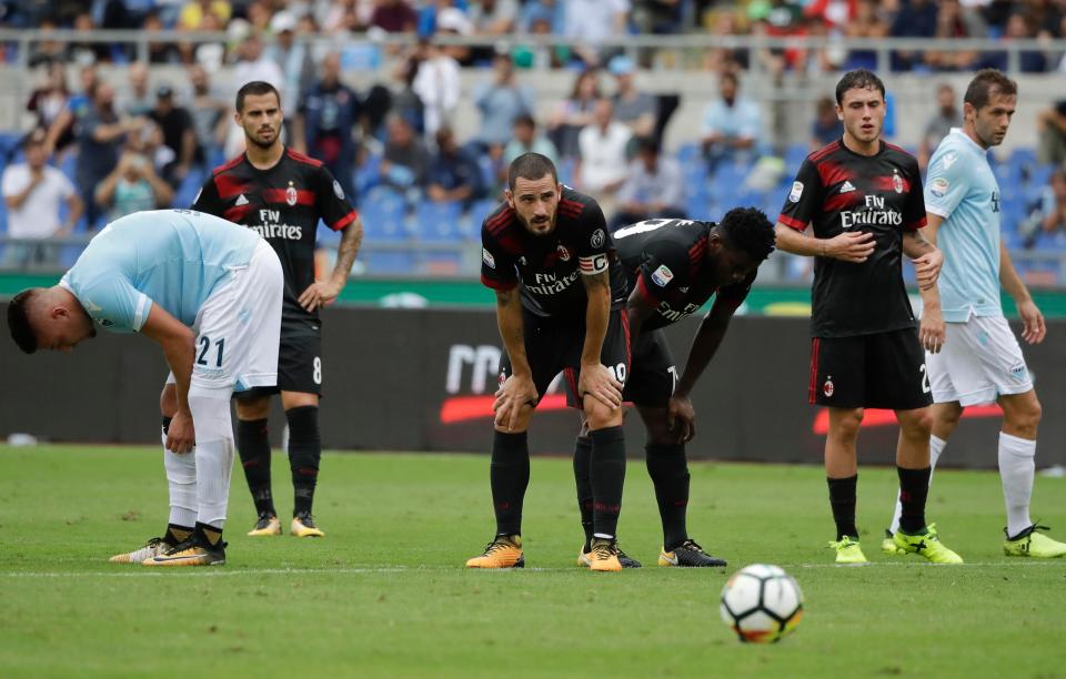  AC Milan players look dejected as a Ciro Immobile treble condemns them to defeat