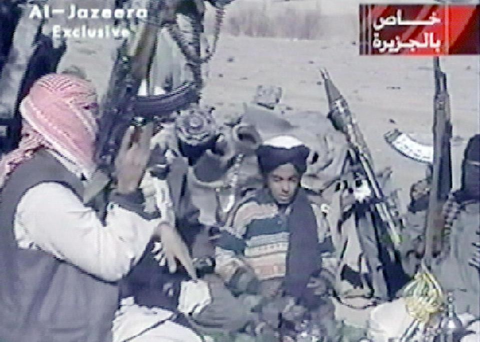  Hamza recites a poem surrounded by armed militia in 2001