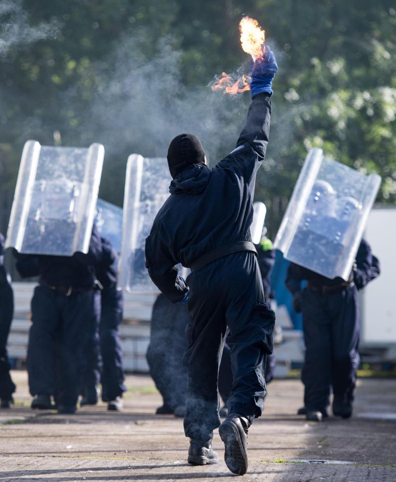  'Lag' hurls a petrol bomb at the oncoming unit