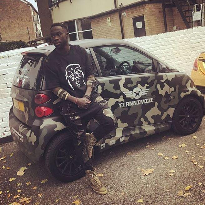  Former Manchester City defender Bacary Sagna poses with a camo smart car