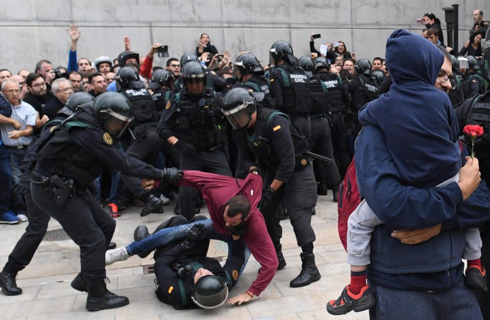  Spanish police dragging voters away from a polling station