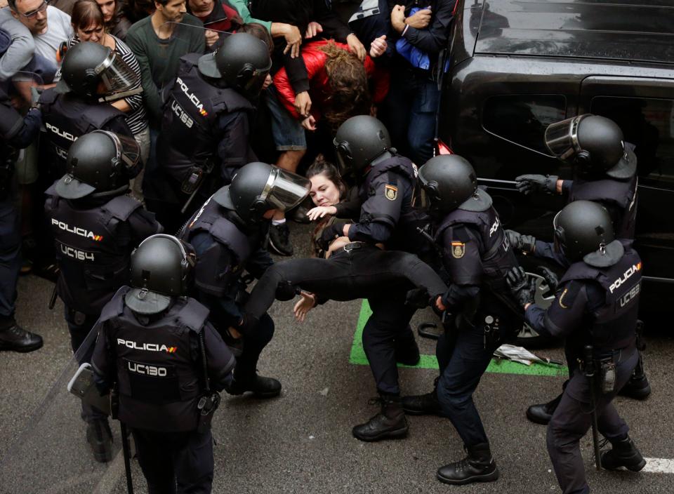  A woman carried away by riot police told to prevent the vote from happening