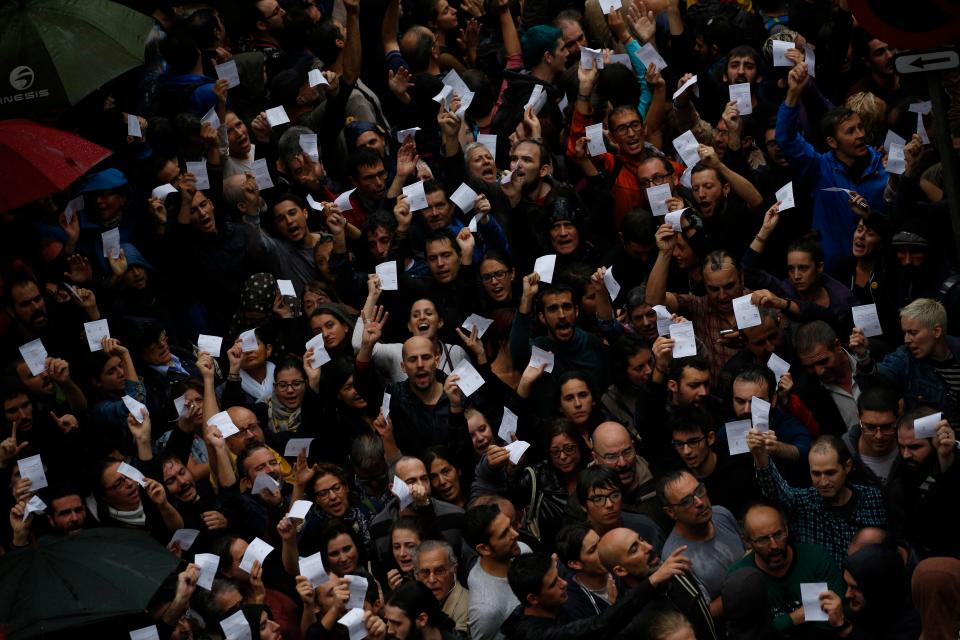  Voters wave their ballot papers as they are prevented from voting by police at Ramon Hull school