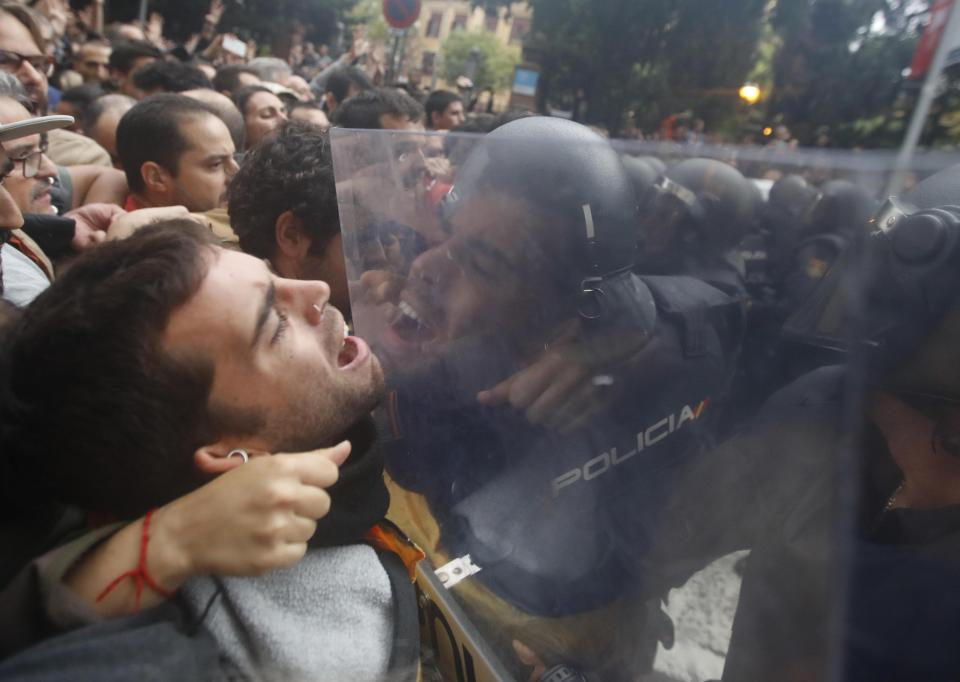  Police hold back crowds of people on Catalan independence vote day