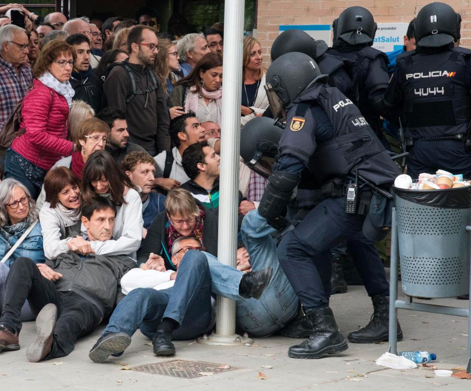  Voters try to resist riot police at a polling station in Cappont, Lleida