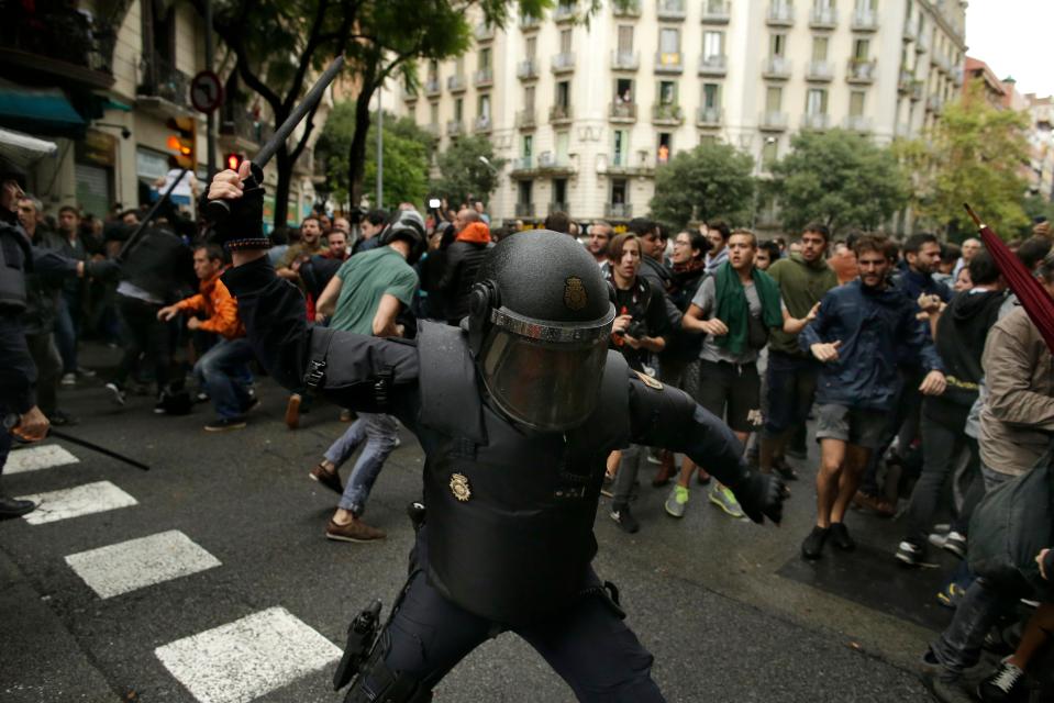  Riot police warn Catalan independence day voters away with batons