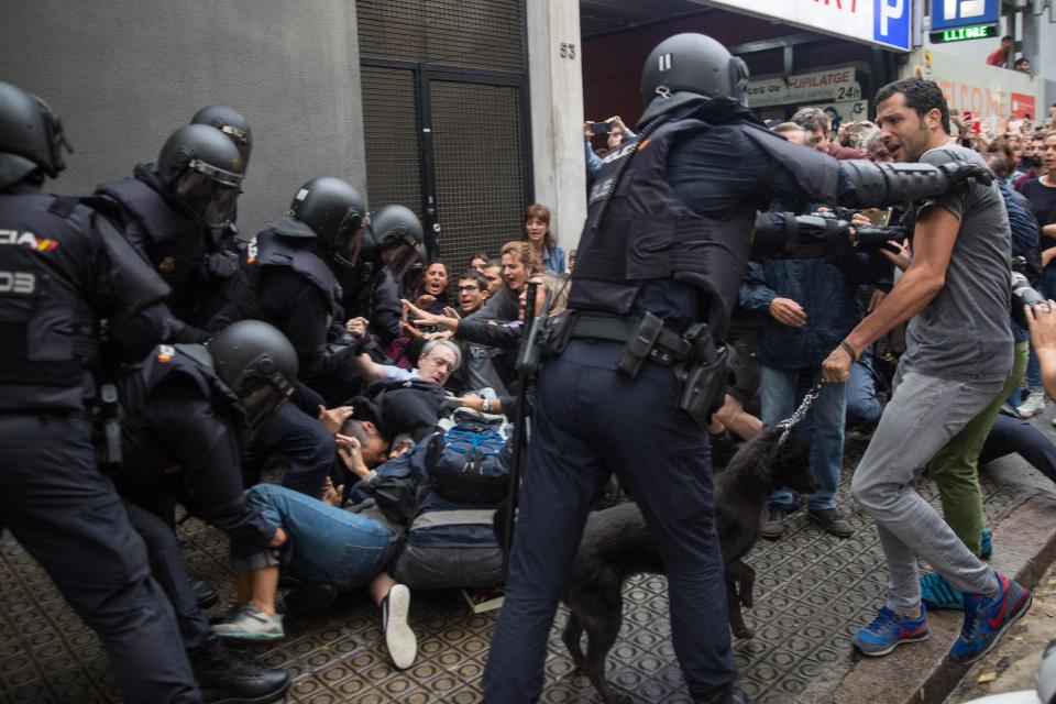  Protesters cower on the ground in front of police in Barcelona