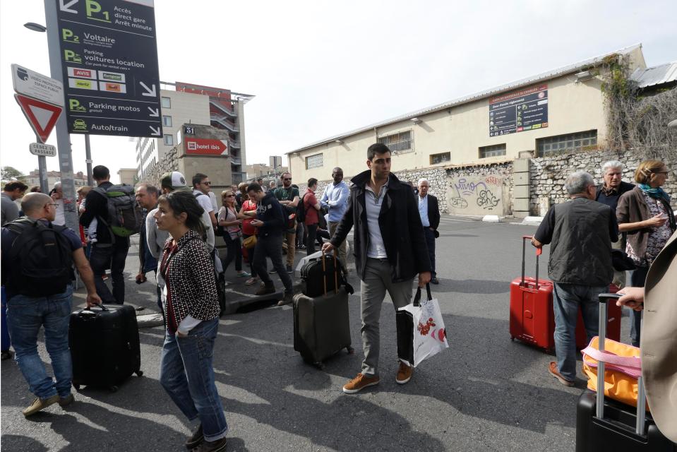  Commuters are left waiting outside the station after their travel plans have been wrecked