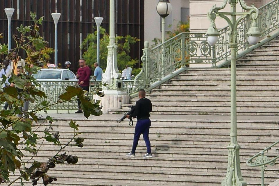  A heavily armed security official parades the scene around Saint Charles station