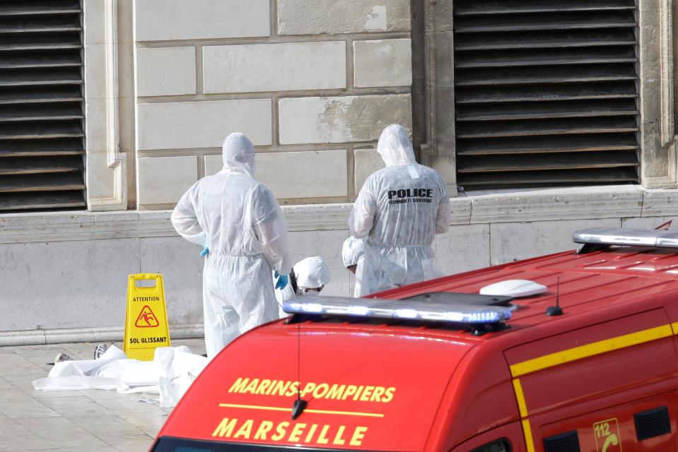  Officials examine the scene of the ambush which started around 2pm local time