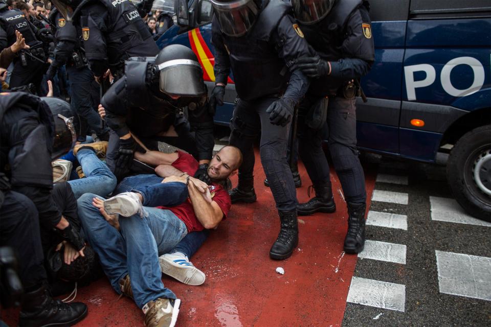  Cops grapple with protesters outside a Barcelona polling station