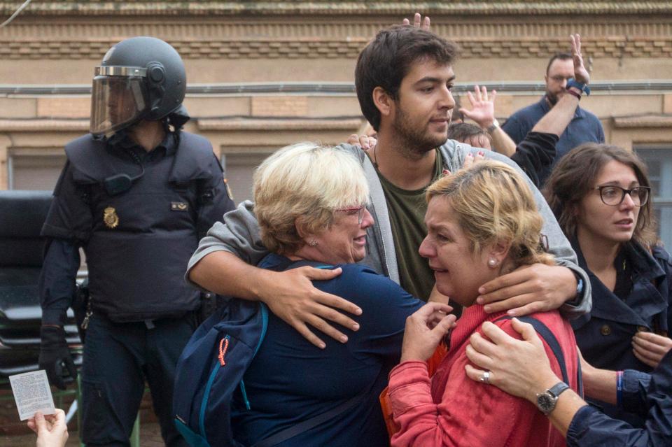  Two women cry and are comforted by a younger voter in L'Hospitalet de Llobregat