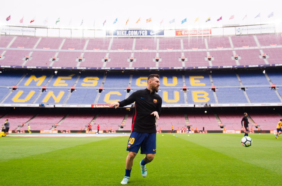 Lionel Messi warms up in front of an empty Nou Camp