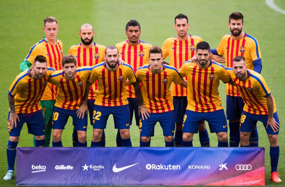 Barcelona stood for their team photo at the Nou Camp wearing warm-up t-shirts in the colours of the Catalan flag