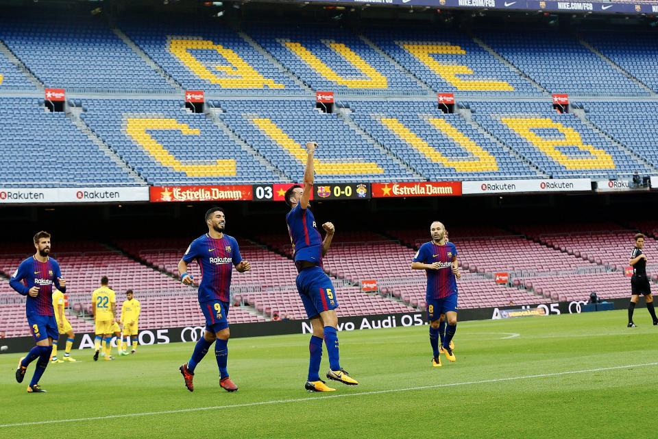  Sergio Busquets celebrates a goal in front of empty stands after Barcelona played behind closed doors