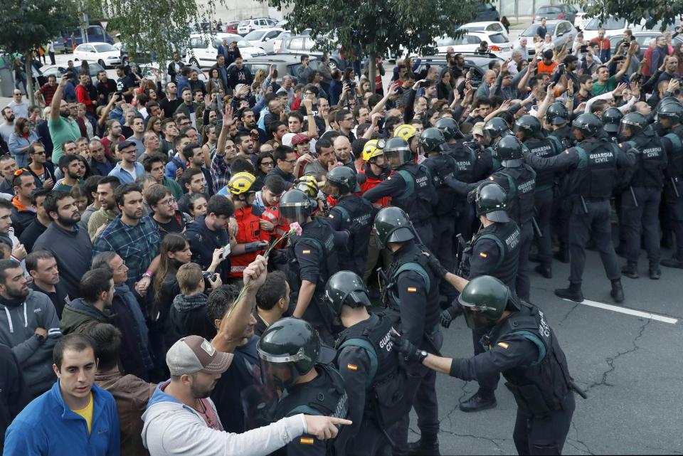  The firefighters linked arms and held back the demonstrators behind them