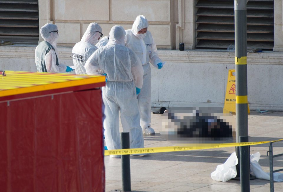  Forensics officers inspect the knifeman's body outside Gare Saint Charles