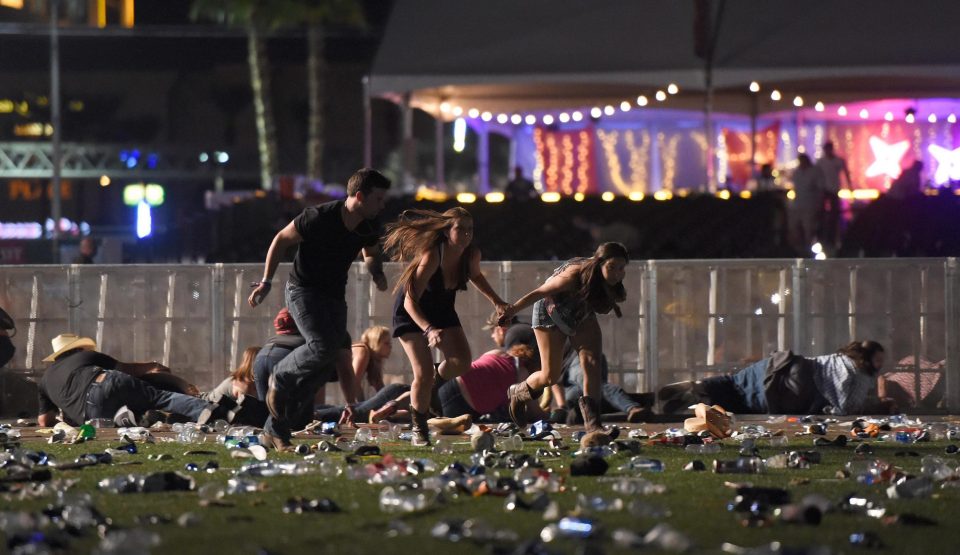  Two women hold hands as a group run for their lives