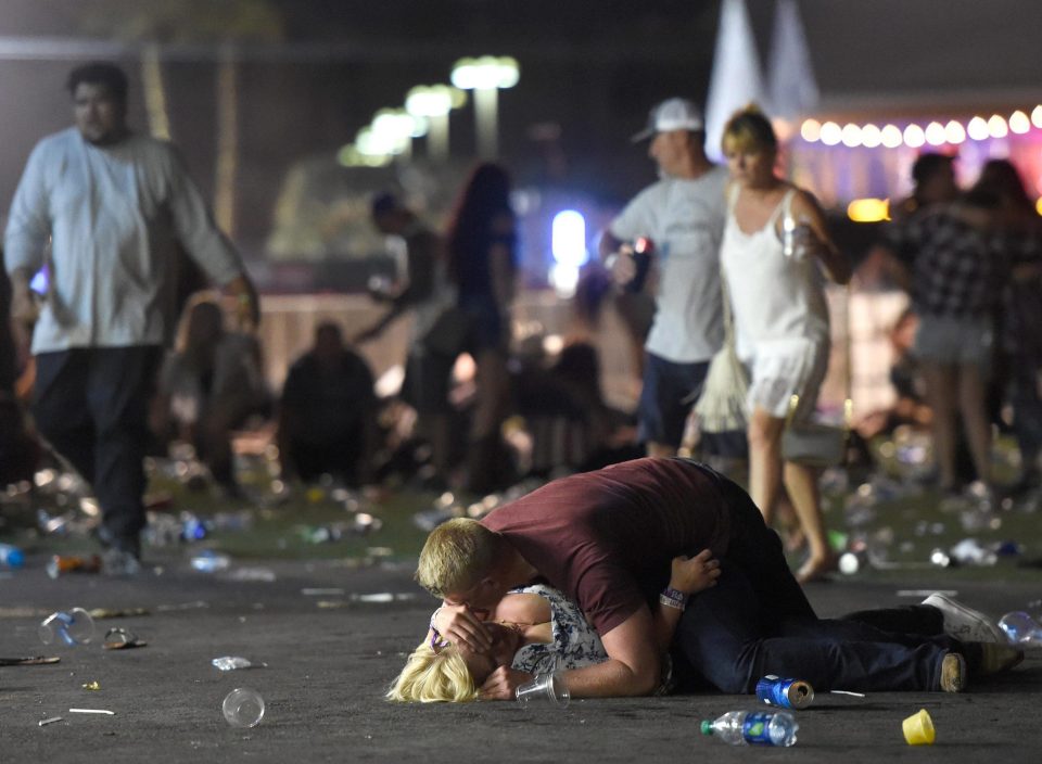  A man holds a woman injured in the horrific attack