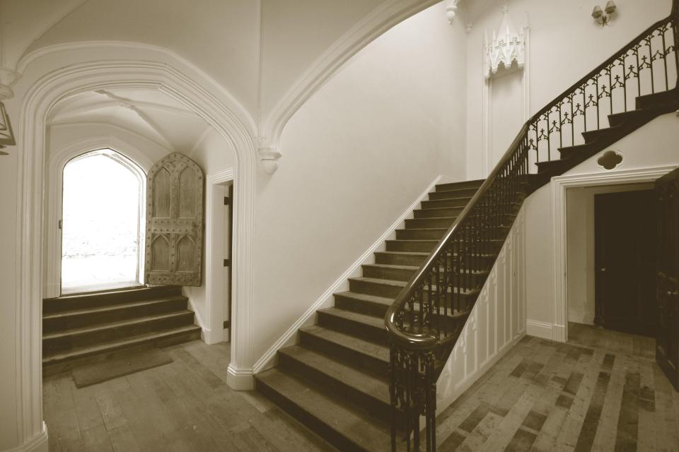  A grand staircase sweeps up from the ground floor to the above levels