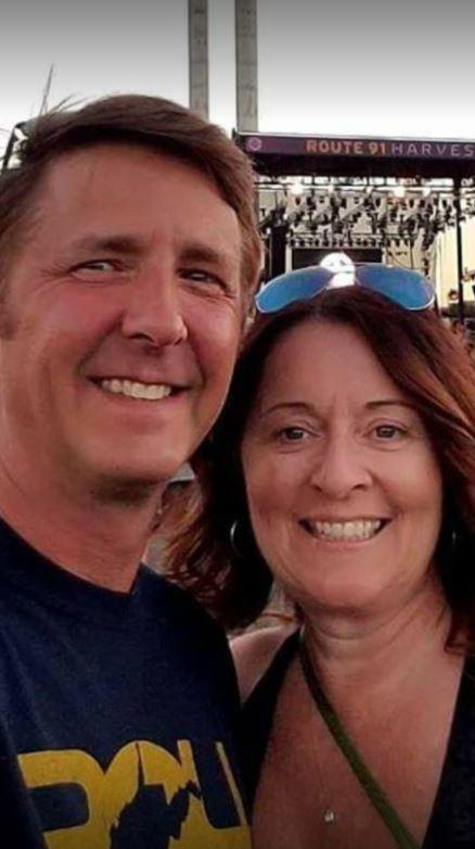 Denise Salmon Burditus, 50, was pictured with her husband Tony Burditus at the festival at 9.30pm just minutes before the shooting began. She too was gunned down