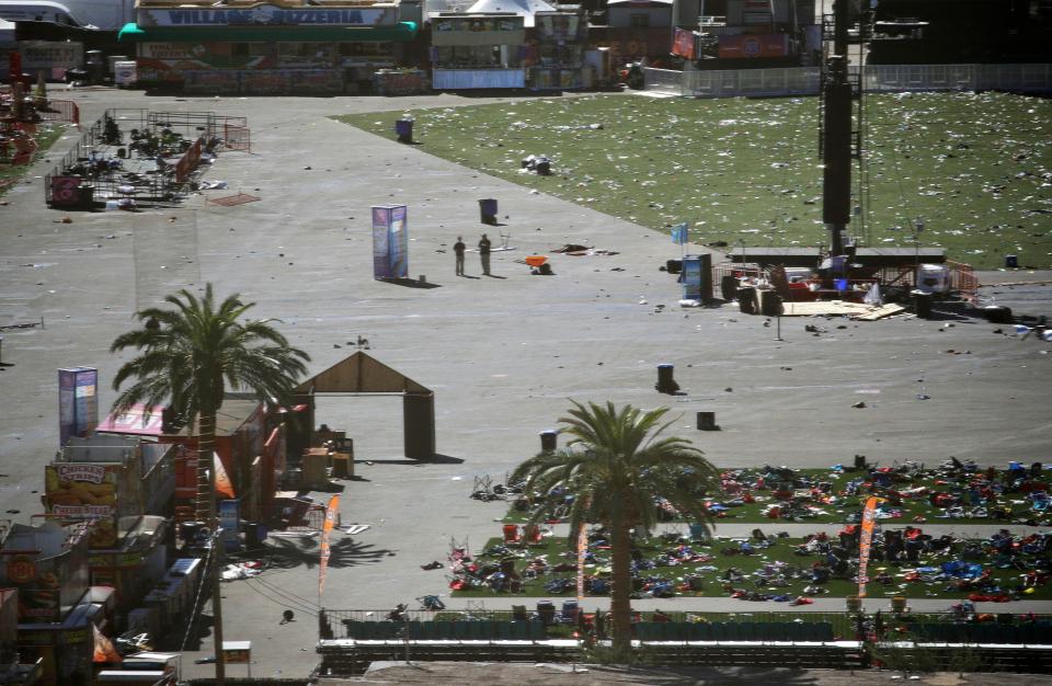  The ground is littered with drink containers and people's belongings that were left behind as they fled