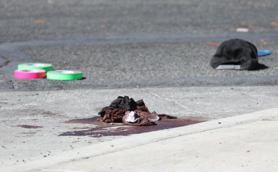  Blood-stained clothing lies where it was left on the road during the massacre