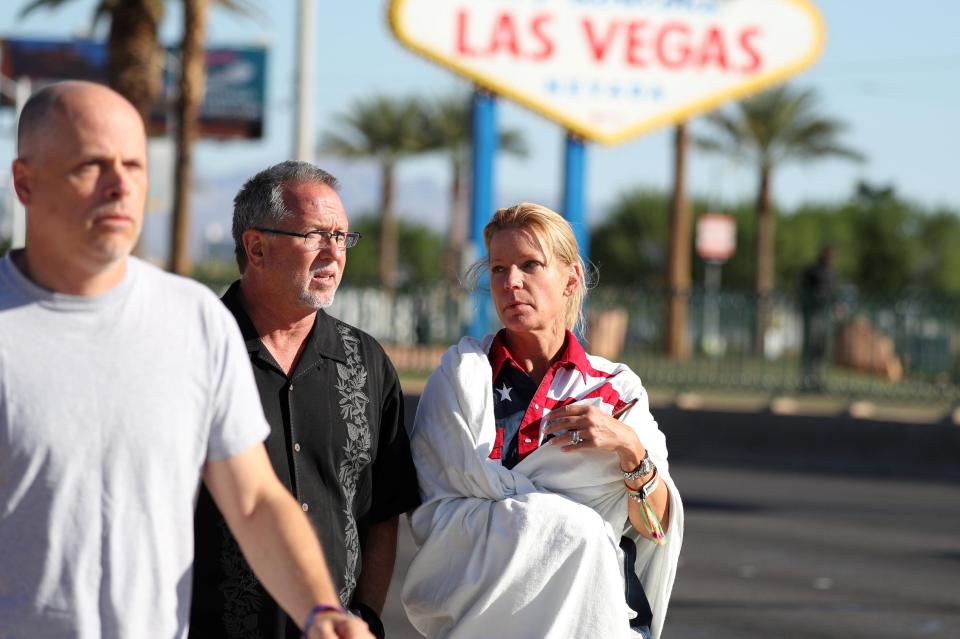  A woman wearing a Route 91 wristband walks near the scene of the attack