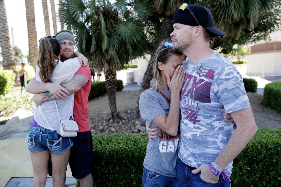  Sobbing witnesses comfort each other the day after the massacre