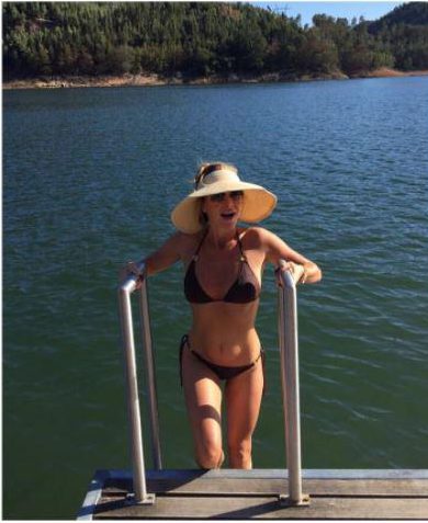 Amanda Holden looked stunning in a black bikini as she prepared for a lake swim in Portugal today 