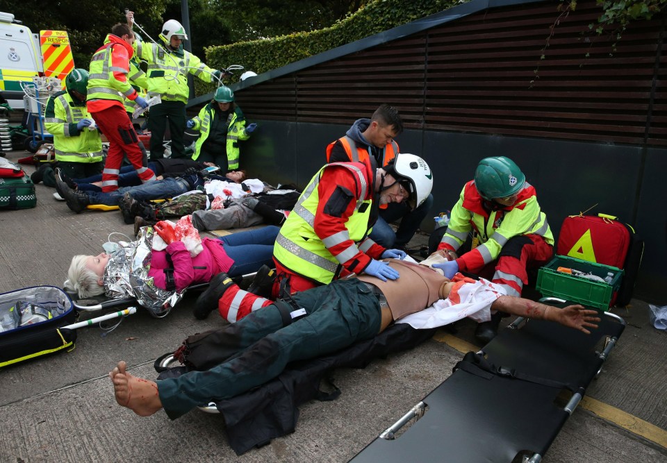 Paramedics treat a wounded victim at the scene of the terror drill today