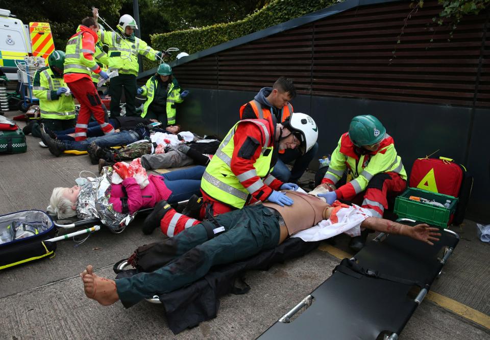  Paramedics treat a wounded victim at the scene of the terror drill today