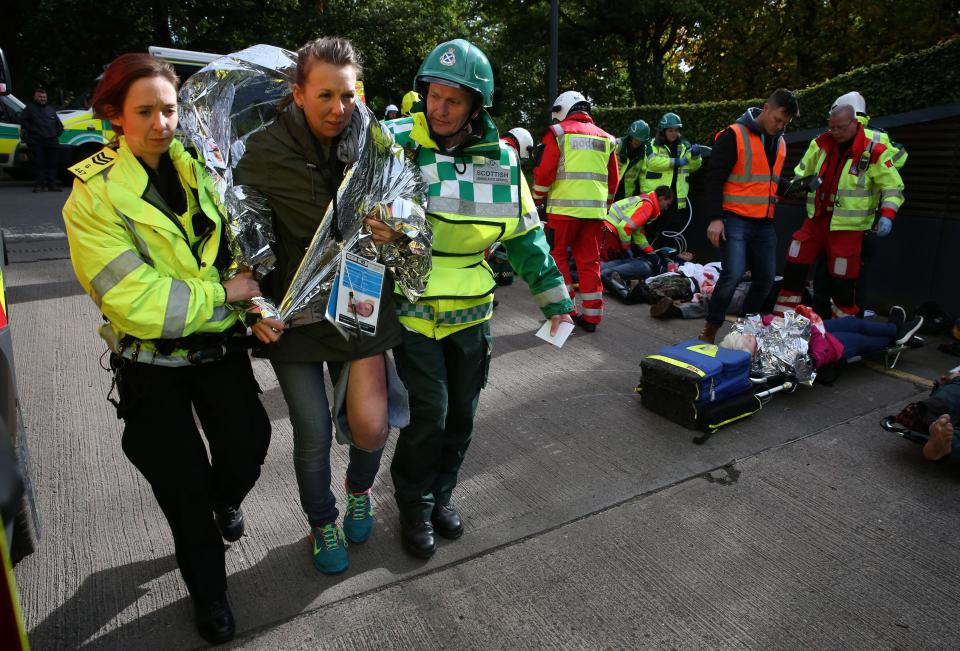  A casualty of the simulated attack is wrapped in a foil blanket by 999 crews