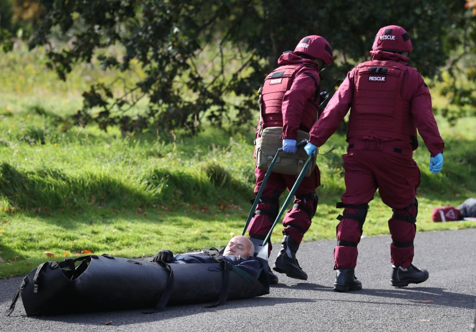 Rescue workers in bomb proof suits stretcher away a casualty during today’s terror training drill