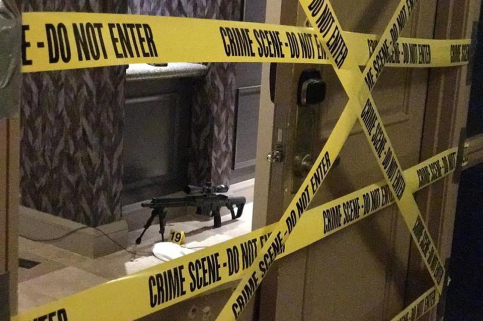 Crime scene tape criss-crossed the smashed-in wooden doors