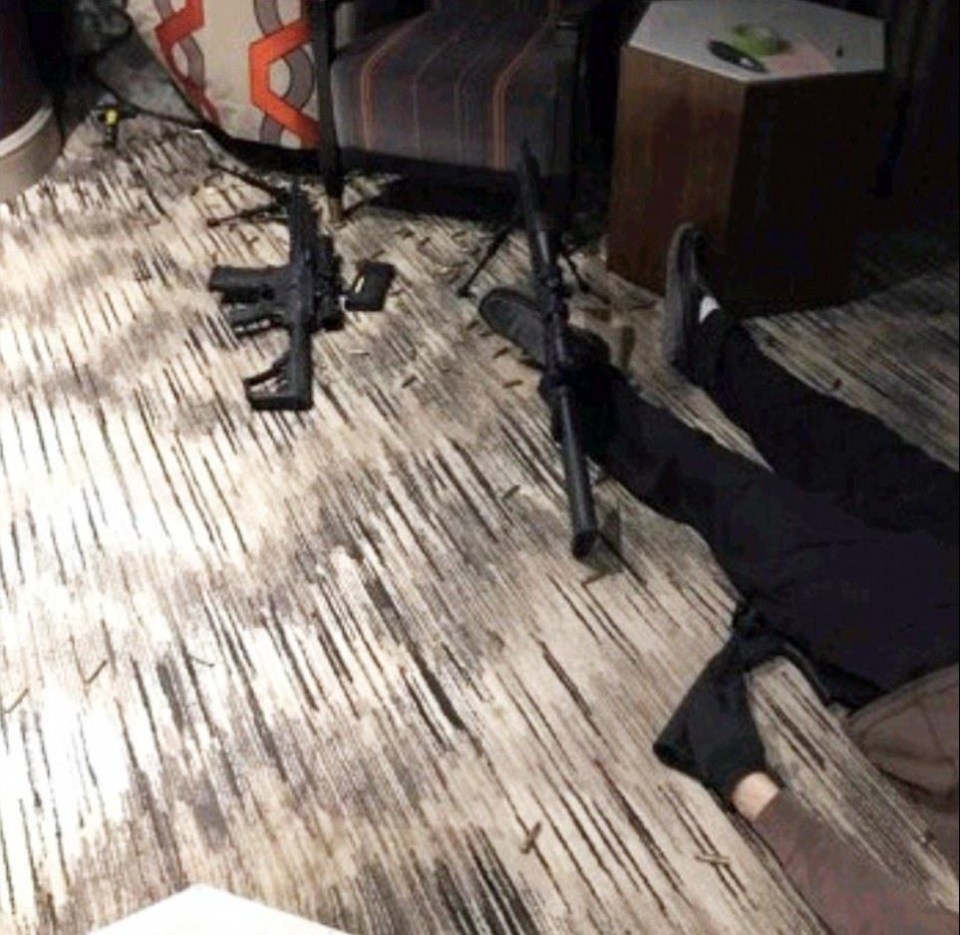 The shooter's body is visible on the floor of the hotel room