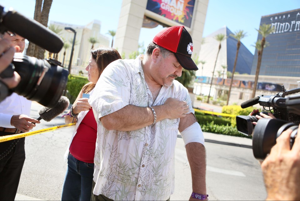 Mass shooting survivor George Sanchez shows where he was shot