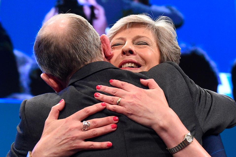  The PM's husband, Philip May, leapt up to hug her after her speech