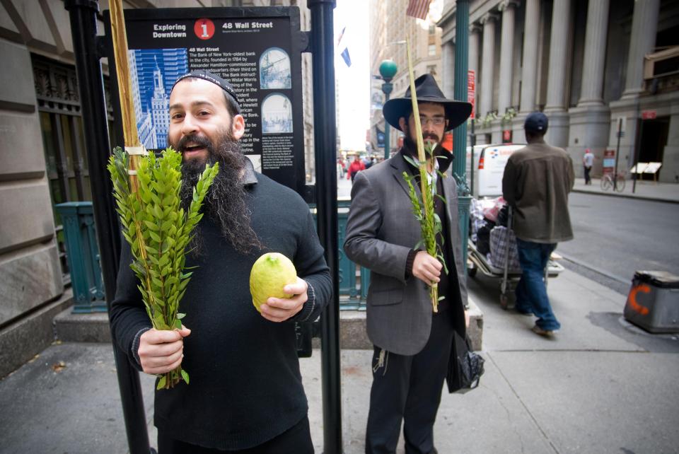  Two Orthodox Jews hold an etrog (citrus fruit) and lulav branch during Sukkot