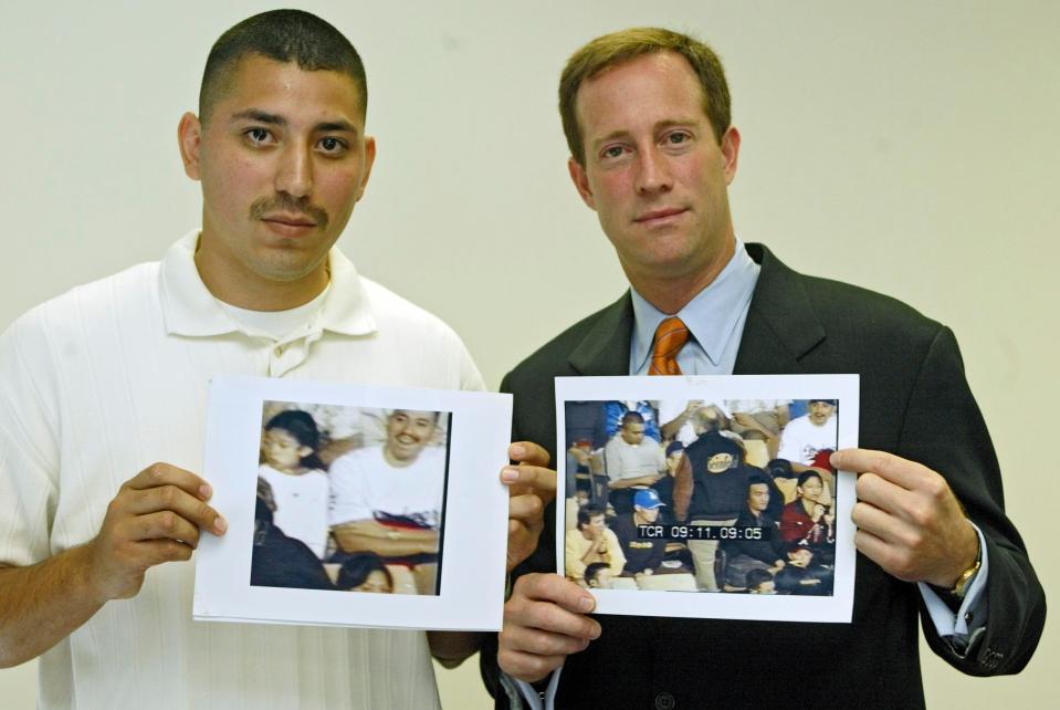  Juan and his defence lawyer Todd Melnik in 2004, holding the proof that Juan wasn't involved in the murder