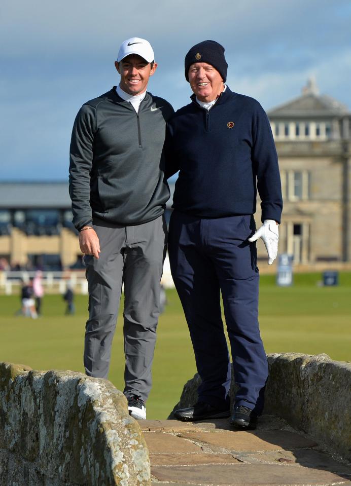  Rory McIlroy with father Gerry McIlroy standing on the Swilken bridge