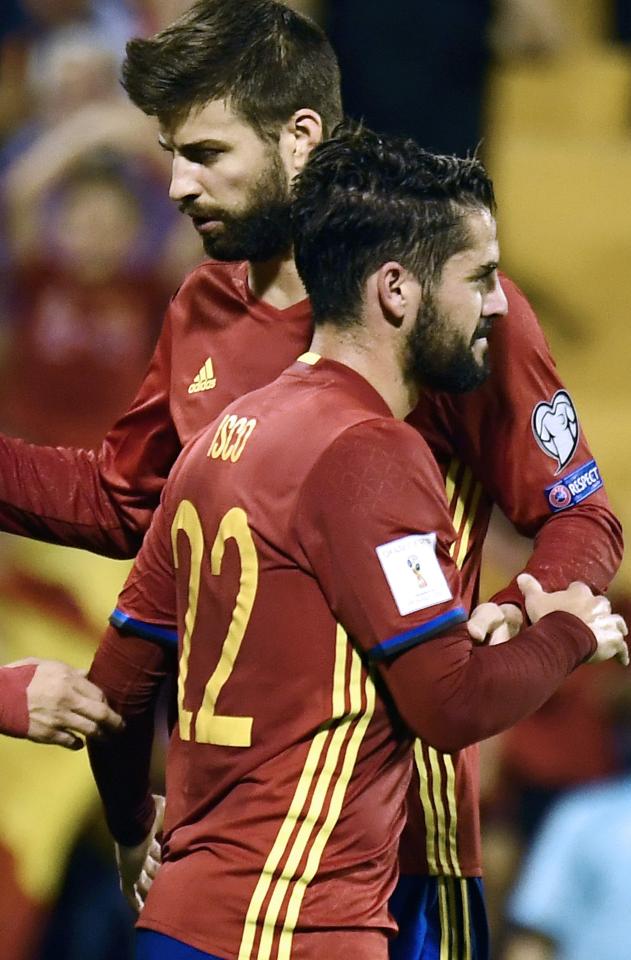  Pique celebrates one of Spain's early goals with Isco