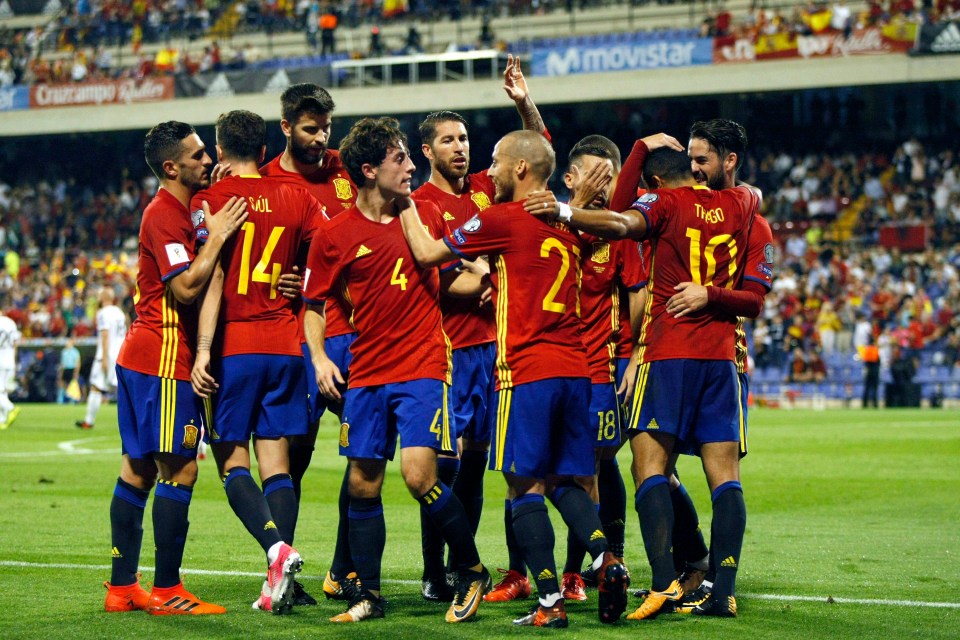 Spain’s players celebrate on their way to booking a World Cup place