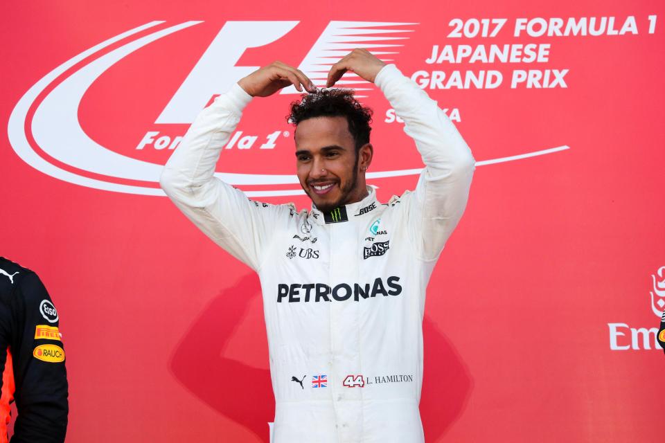  Hamilton adopts Farah's signature pose after the race