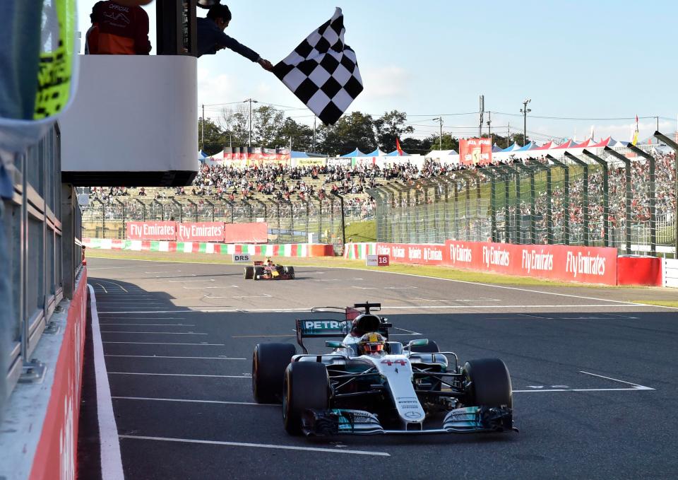  Lewis Hamilton crosses the line in first place at the Japanese GP