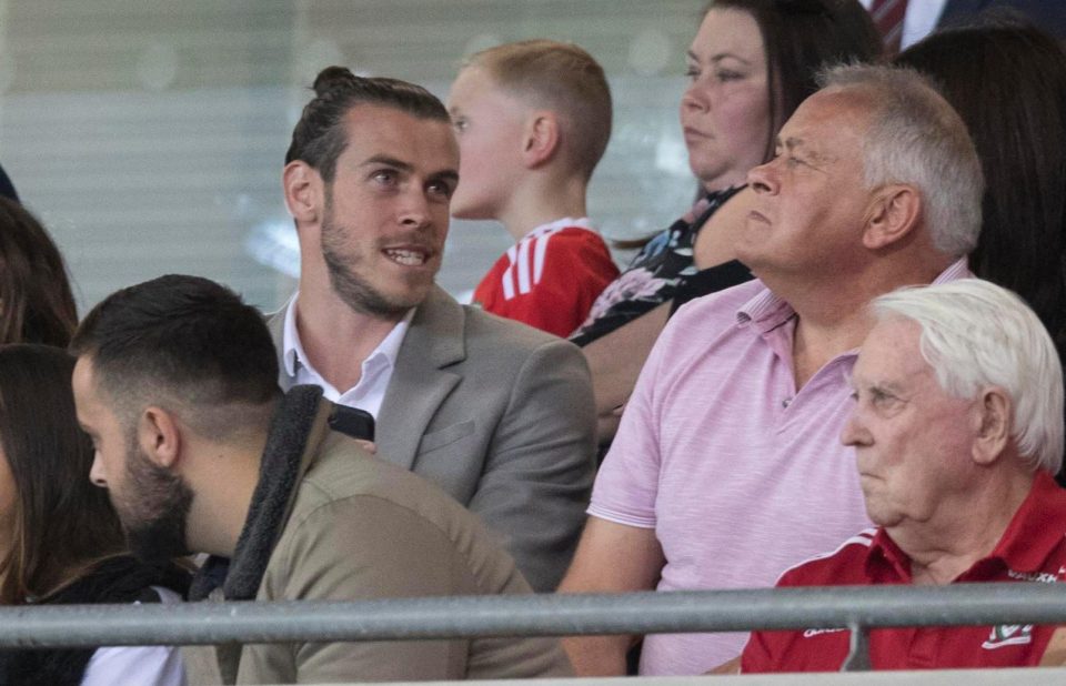  Gareth Bale chats to dad Frank during the match at the Cardiff City Stadium